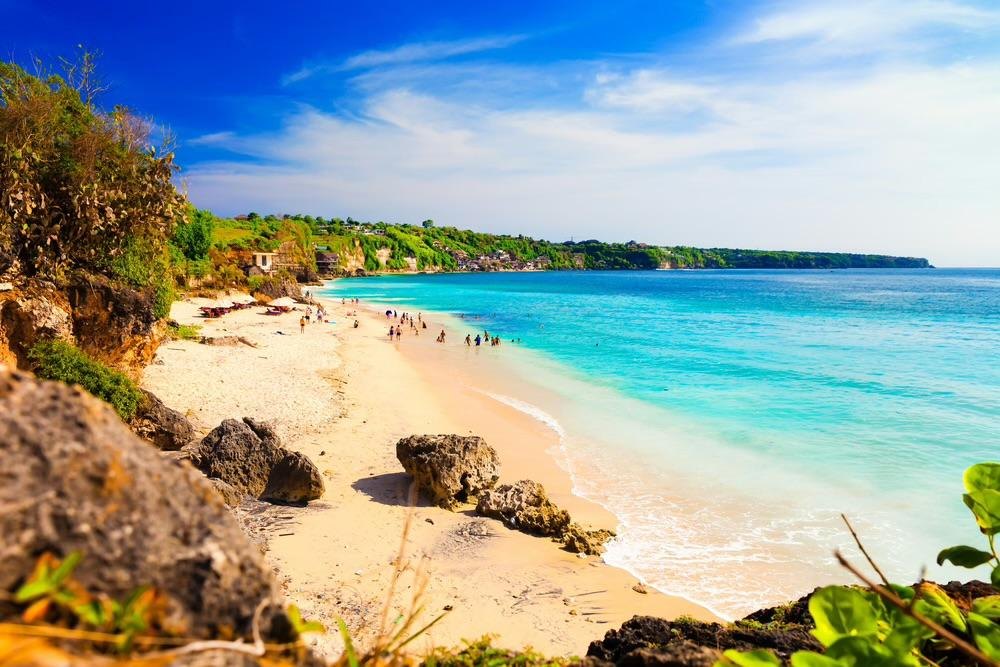 A turquoise bay below the cliffs of Bali's Bukit Peninsula in the dry season